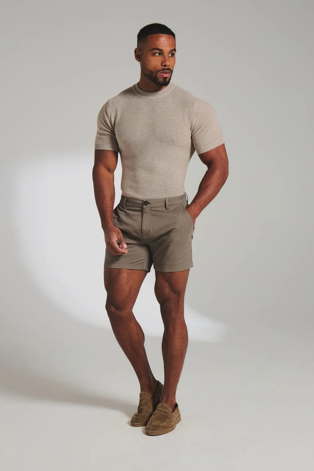 Model in a grey t-shirt and grey shorts